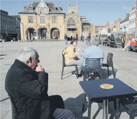  ??  ?? Enjoying a coffee on Cathedral Square.