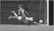  ?? PHOTO BY ROB WORMAN ?? La Plata High School goalkeeper Ben LeBarron makes a diving save to deny Calvert freshman Braxton Gibbons of the tying goal in Tuesday’s penalty kick shootout. The two teams played to a scoreless draw through regulation and overtimes, but the Warriors...