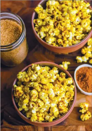  ?? TRIBUNE CONTENT AGENCY ?? Try mixing the curried popcorn with a plain batch for a variation on texture and taste.