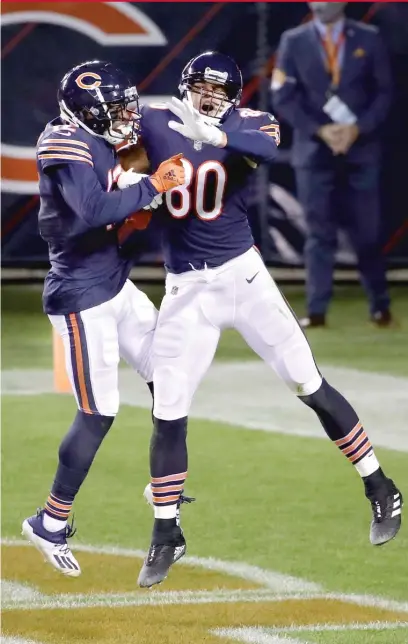  ?? GETTY IMAGES ?? Allen Robinson ( left) and Jimmy Graham celebrate after Graham’s touchdown catch in the second quarter Thursday.