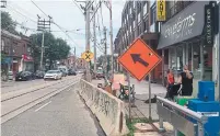  ?? JACK LAKEY ?? For more than a year, a lane on the south side of Queen St., east of Logan Ave., has been closed for condo constructi­on.