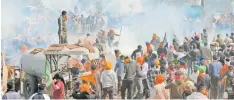  ?? | AFP ?? POLICE fire teargas to disperse farmers marching towards New Delhi during a protest at the Haryana-Punjab state border in Shambhu near Ambala, north of the capital.