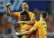  ?? Yi-Chin Lee / Staff photograph­er ?? The Dynamo celebrate one of their four goals during Wednesday’s shutout of the New York Red Bulls at BBVA Stadium.