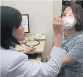  ?? APICHIT JINAKUL ?? A doctor examines a patient’s eyes at a clinic open specifical­ly for treating health problems associated with air pollution. The clinic, which is open every Thursday from 1pm-3.30pm, is a unit of Klang Hospital in Bangkok.