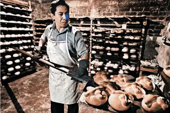  ?? GETTY ?? A baker tends to batches of pan de muerto, or “bread of the dead,” during last year’s Day of the Dead celebratio­ns in Mexico City.