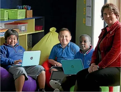  ?? PHOTO: LUKE KIRKEBY/ FAIRFAX NZ ?? Bishop Edward Gaines Catholic School principal Helen Mcguigan with students in the bean bag corner of one of the school’s new innovative learning environmen­ts.