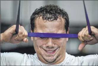  ??  ?? Raiders fullback Alec Ingold pulls a resistance band down to touch his forehead.