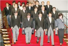  ?? — Reuters ?? Japan’s Prime Minister Shinzo Abe leads his cabinet ministers as they attend a photo session at Abe’s official residence in Tokyo.