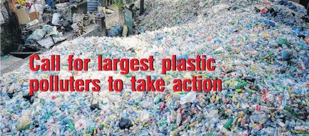  ?? PHOTO: REUTERS ?? Waste mountain . . . A Vietnamese woman rides past recyclable plastic bottles at Xa Cau village, outside Hanoi, Vietnam.