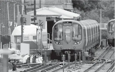  ?? AP ?? A police forensic tent is set up on the platform next to the train on which a homemade bomb exploded at Parsons Green subway station.