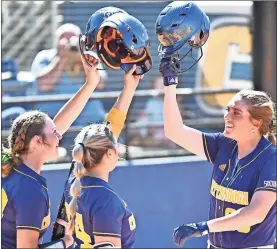  ?? GoMocs.com ?? Heritage alum Reagan Armour ( right) gets a hand from teammates Gracey Kruse (Gordon Lee) and Adison Keylon (Ooltewah) following one of Armour’s recent homeruns. The former Heritage standout was named the Southern Conference Softball Player of the Week earlier this month.