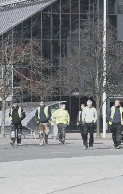  ??  ?? 0 Workers outside the SECC in Glasgow which is being made into a temporary hospital where