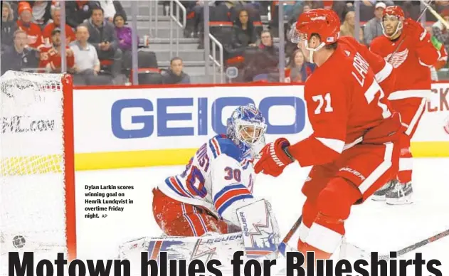  ?? AP ?? Dylan Larkin scores winning goal on Henrik Lundqvist in overtime Friday night.