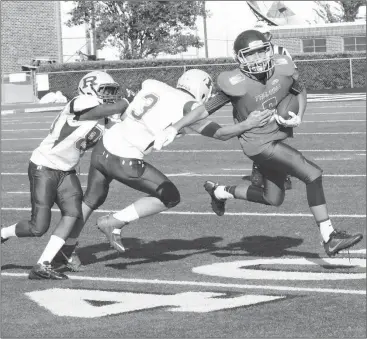  ??  ?? Rossville’s Malik Byrd (left) and Landon Ownby (3) try and corral Gordon Lee’s Brody Cobb during last Thursday’s middle school game in Chickamaug­a. The Bulldogs scored three times in the first quarter and held on late for an 18-14 win that saw them...