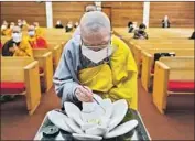  ?? Jason Armond Los Angeles Times ?? A BUDDHIST priest joins a ceremony at a temple in L.A. on Tuesday, 49 days after the Atlanta shootings.