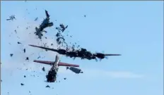  ?? Associated Press ?? A Boeing B-17 Flying Fortress and a Bell P-63 Kingcobra collide in midair Saturday during an airshow at Dallas Executive Airport in Dallas.