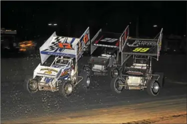  ??  ?? Racing goes three-wide between race winner Kyle Smith (17), Tommy Carberry and Stef Carberry in the MASS Sprint Series feature at Georgetown Speedway on Oct. 28.