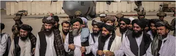  ??  ?? Taliban officials, including Zabihullah Mujahid, third from right, announcing victory at the airport in Kabul, Afghanista­n, on Tuesday, Aug. 31, 2021