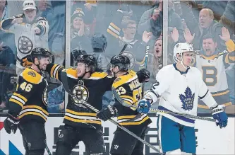  ?? MICHAEL DWYER THE ASSOCIATED PRESS ?? Boston Bruins’ David Krejci (46) celebrates his goal with teammates Brad Marchand (63) and David Pastrnak as Toronto Maple Leafs’ Nikita Zaitsev skates away during the third period Saturday.