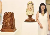  ??  ?? SM senior vice president Millie F. Dizon beside the artworks of Mandukit Anluagi Sta. Ursula (MASU) artists Francis Sibug for “Mother and Child” and Ardie De Dios for the bust of Mama Mary