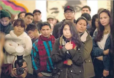  ?? Photograph­s by Steve Saldivar Los Angeles Times ?? A CROWD listens to poetry at the Boyle Heights Arts Conservato­ry. All 15 featured artists — Asian, Latino and black singers, poets and painters — are in the country illegally, down to the DJ.