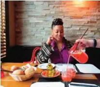  ??  ?? Photo shows Lauren Craig, who calls herself the ‘glambassad­or’ of Newark, NJ, watching as sangria is poured into a glass at Casa d’Paco, a Spanish restaurant in the Ironbound section of Newark.