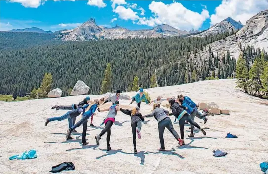  ?? Patrick Bremser ?? A YOGA RETREAT group practices together at Yosemite National Park’s Tuolumne Meadows Campground with the dramatic background of the Cascade Range.