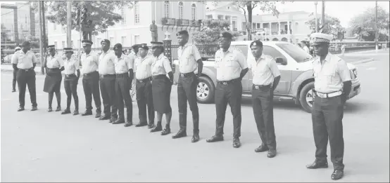  ??  ?? The squad of police on hand at Parliament yesterday morning.