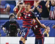  ?? RON SCHWANE — THE ASSOCIATED PRESS ?? Matt Miazga (4) celebrates with Chris Pontius (7) after scoring a goal during a Gold Cup match at First Energy Stadium on July 15.