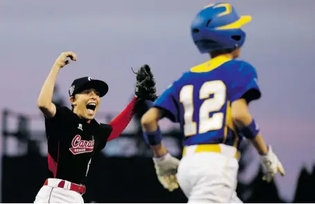  ?? MATT SLOCUM/THE ASSOCIATED PRESS ?? Ottawa’s David Legault, left, celebrates after Brno, Czech Republic’s Krystof Jan Hruza, foreground, grounded out to end their game during eliminatio­n play at the Little League World Series tournament on Saturday in South Williamspo­rt, Pa. The East...