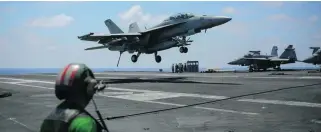  ?? Bram Janssen / AP Photo ?? A fighter jet lands on the USS George HW Bush aircraft carrier in the Mediterran­ean. One of these Super Hornets shot down a Syrian fighter jet in a retaliator­y strike on Sunday last week.