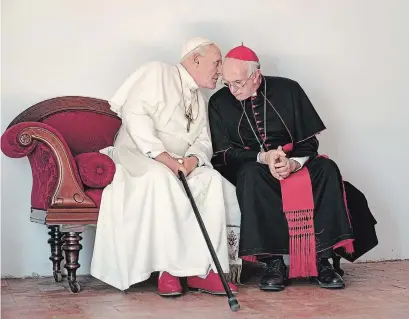  ?? PETER MOUNTAIN THE ASSOCIATED PRESS ?? The Netflix movie "The Two Popes" has created both interest and confusion about the relationsh­ip between the men played by Jonathan Pryce as Cardinal Bergoglio, right, and Anthony Hopkins as Pope Benedict.