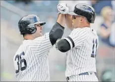  ?? Kathy Willens / Associated Press ?? The Yankees’ Brett Gardner, right, celebrates with Mike Ford after his tying HR in the ninth. Ford then hit his winning blast.