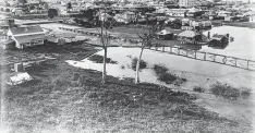  ??  ?? HARD TIMES: Sections of Cairns inundated with high tides and flooding, circa 1920. Picture: NATIONAL LIBRARY OF AUSTRALIA