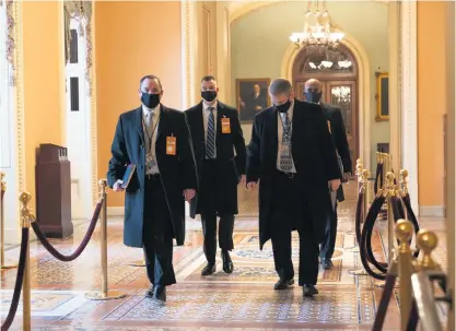  ?? AP ?? On guard: Security officials survey the Capitol in Washington ahead of the scheduled presidenti­al inaugurati­on.