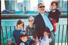  ??  ?? Hasan Al Khatib, Ahmad’s father, with his grandchild­ren in Abu Dhabi. Ahmad is celebratin­g this Eid in Palestine.