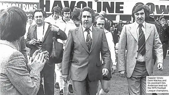  ?? ?? Happier times: Dave Mackay and his assistant Des Anderson lead out the 1975 Football League champions.