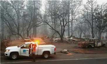  ??  ?? Under probe: Employees of PG&amp;E work in the aftermath of the Camp Fire in Paradise, California. California authoritie­s are investigat­ing PG&amp;E equipment as a possible cause of the so-called Camp Fire, the deadliest blaze in state history. — Reuters