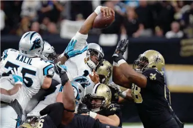  ?? Associated Press ?? Carolina Panthers quarterbac­k Cam Newton (1) reaches over the pile for a first down in the first half of an NFL football game against the New Orleans Saints on Sunday in New Orleans.
