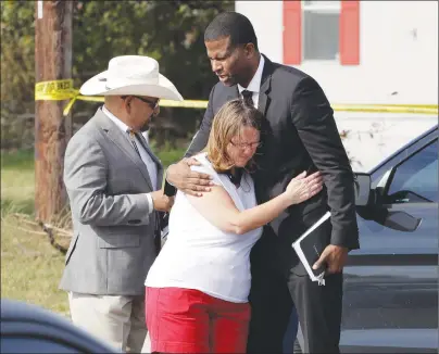  ??  ?? Pastor Dimas Salaberrio­s, right, prays with Sherri Pomeroy near the First Baptist Church of Sutherland Springs, Monday, Nov. 6, 2017, in Sutherland Springs, Texas.