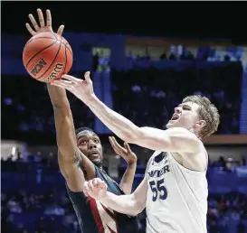  ?? Andy Lyons / Getty Images ?? Xavier’s J.P. Macura, right, goes up for a shot against Florida State’s Trent Forrest in the second half of Sunday night’s game at Nashville, Tenn.