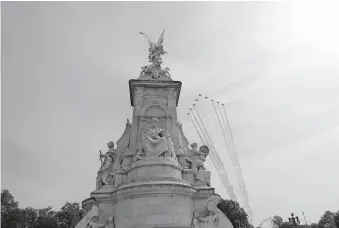  ?? [AP PHOTO/FRANK AUGSTEIN] ?? The Red Arrows, officially known as the Royal Air Force Aerobatic Team flies over the Queen Victoria Memorial outside Buckingham Palace in London, Friday, May 8, 2020 on the 75th anniversar­y of the end of World War II in Europe. The 75th anniversar­y of the end of World War II in Europe should be all about parades, remembranc­es, and one last great hurrah for veteran soldiers who are mostly in their nineties. Instead, it is a time of coronaviru­s lockdown and loneliness spent in search of memories both bitter and sweet.