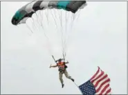  ?? PETE BANNAN — DIGITAL FIRST MEDIA ?? Steven Loufek of Skydive Crosskey opens the 12th Annual Chester County Balloon Festival with the American flag June 22. Loufek jumped from 5,000 feet. “The flag makes things challengin­g,”Loufek said. “The winds were stiff at 30 knots at 3,000 feet.”