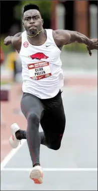  ?? NWA Democrat-Gazette/ANDY SHUPE ?? Arkansas triple jumper Clive Pullen braved cold temperatur­es and brisk winds to post a distance of 52 feet, 7 ½ inches Saturday at the John McDonnell Invitation­al in Fayettevil­le.