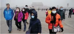  ??  ?? BEIJING: This file photo shows a group of people wearing masks during a visit to Tiananmen Square in Beijing. — AFP photos