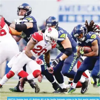  ??  ?? SEATTLE: Running back J.D. McKissic #21 of the Seattle Seahawks rushes in the third quarter against the Arizona Cardinals at CenturyLin­k Field on Sunday, in Seattle, Washington. — AFP