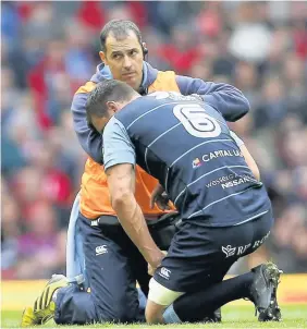  ??  ?? Warburton receives treatment after picking up a knock to his shoulder during the Blues’ Judgement Day clash with the Ospreys