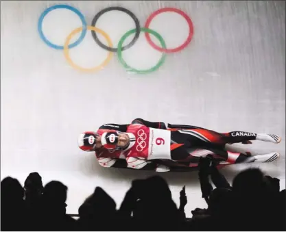  ?? The Canadian Press ?? Tristan Walker and Justin Snith of Canada compete in Heat 1 of men’s luge doubles during the 2018 Olympic Winter Games in Pyeongchan­g, South Korea on Wednesday. Walker and Snith finished fifth.