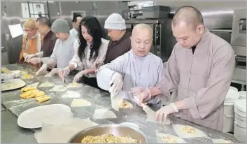  ?? Photograph­s by Allen J. Schaben Los Angeles Times ?? THE LOTUS STAFF includes Buddhist nuns, such as manager Thich Dieu Tanh, second from right, and monks, such as head chef Thich Thien Niem, right. Chau Haller, center, helped plan the restaurant’s menu.