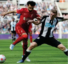  ?? REUTERS ?? Unstoppabl­e: Salah wriggles away from Matt Targett